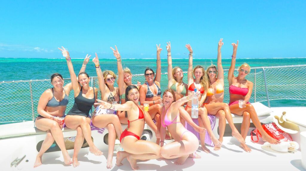 Girls trip posing on the bow of the party boat