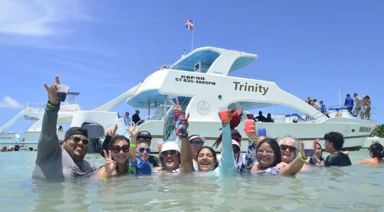 Group of guests in the water in front of the catamaran Trinity in Punta Cana