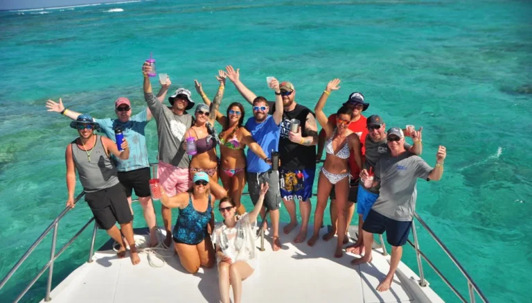 Group of guests celebrating at the bow over the turquoise sea in Punta Cana