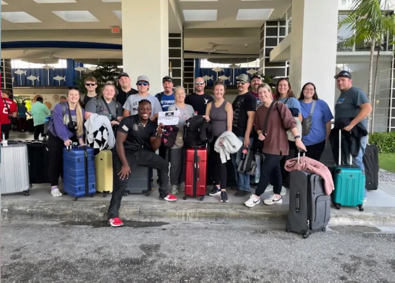 Yobi with a group of travelers and their luggage at the airport pickup in Punta Cana