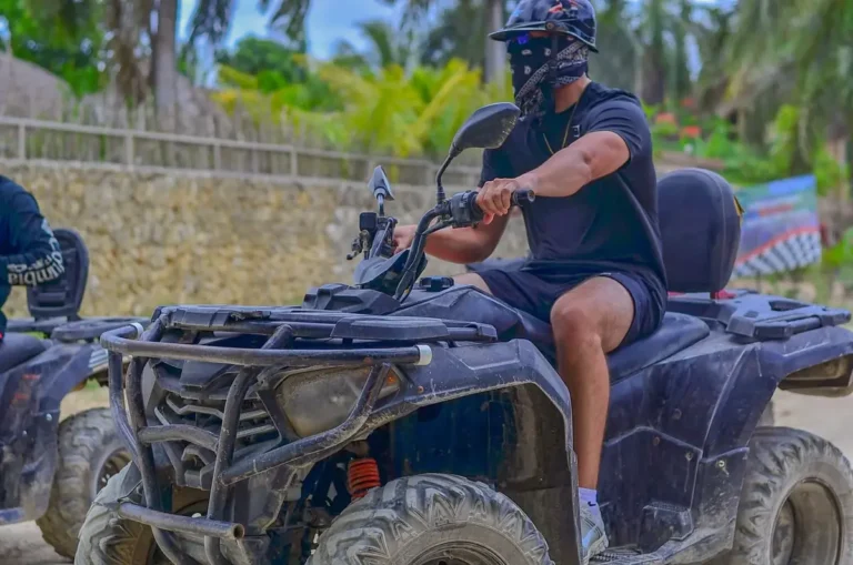 Guest riding an ATV on a dirt road through the Dominican countryside