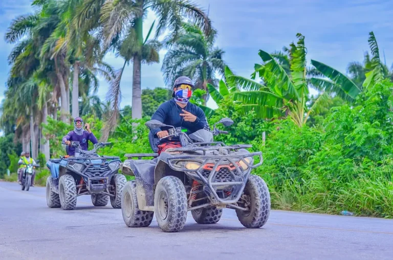 Guests riding ATVs through green countryside on the Punta Cana route