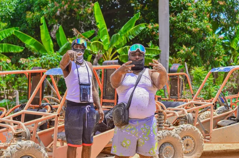 Two guests in helmets beside the row of buggies before the ride in Punta Cana