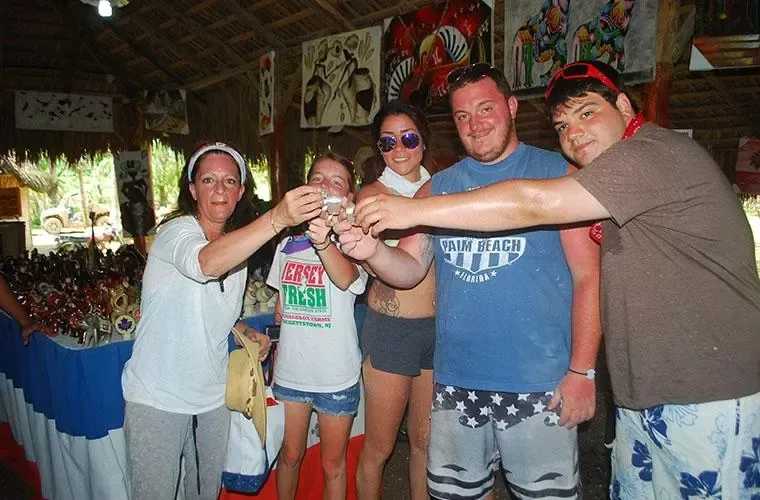 Group of guests toasting with small glasses during the local tasting