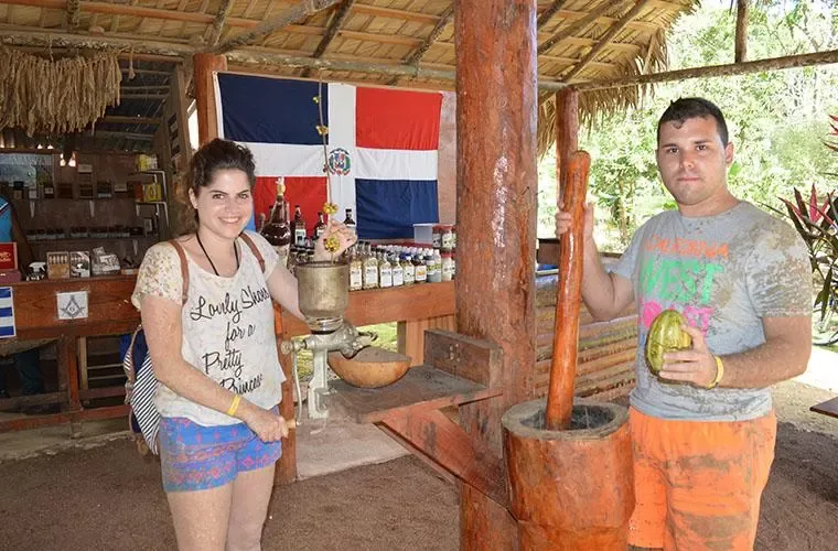 Couple at a stall of local products with a Dominican flag