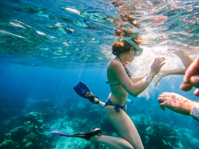 Snorkeler with mask and fins over the coral reef at Catalina Island