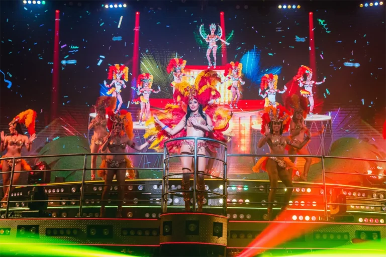Samba dancers in feathered costumes on the Coco Bongo stage