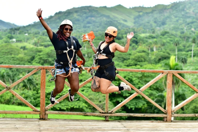 Two guests jumping for joy at a mountain lookout at La Hacienda Park