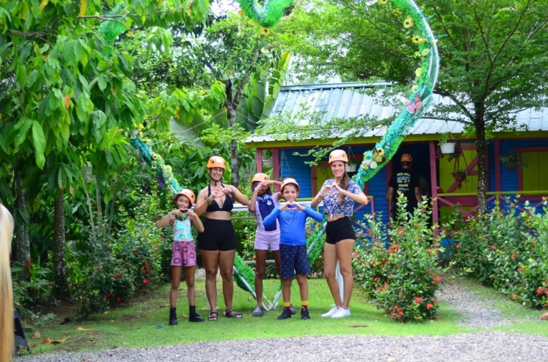 Family in front of a colorful sign at La Hacienda Park