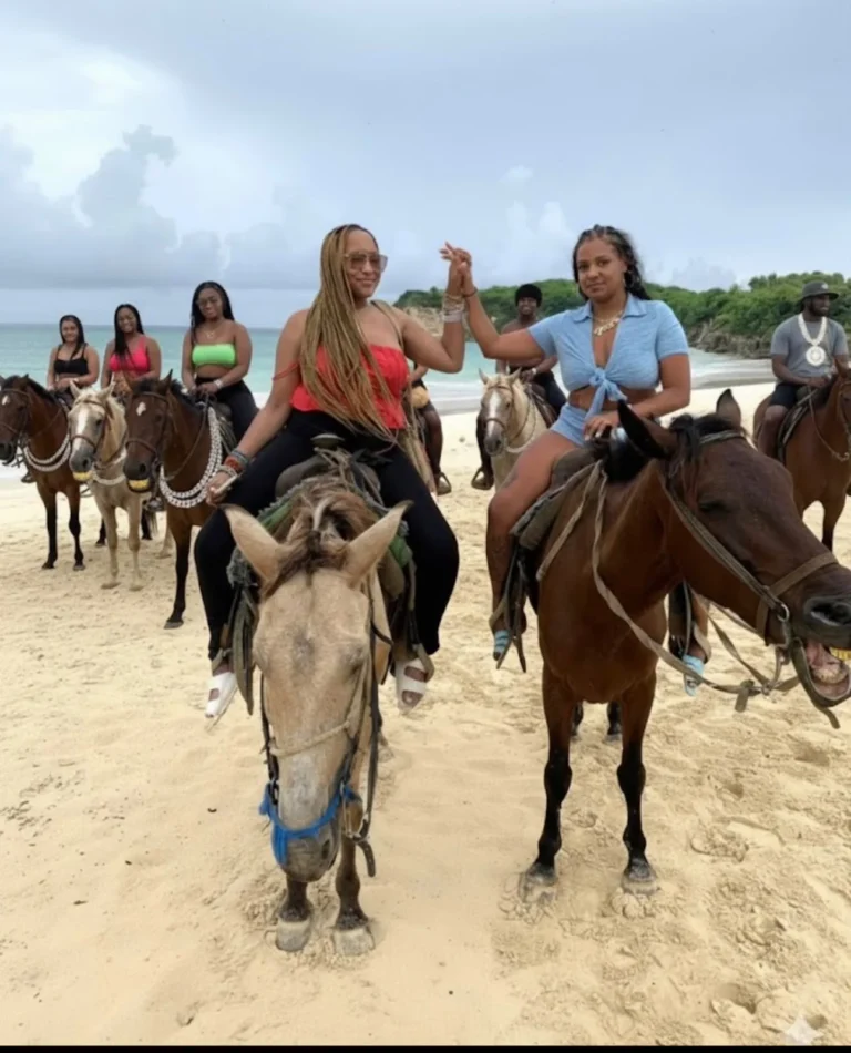 Group of friends riding horses on the beach in Punta Cana