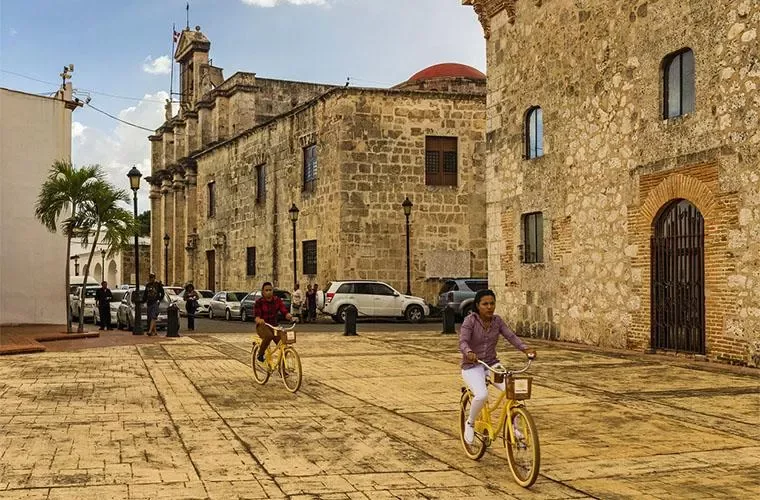 Stone facade of the Cathedral of Santo Domingo beside a Colonial Zone street