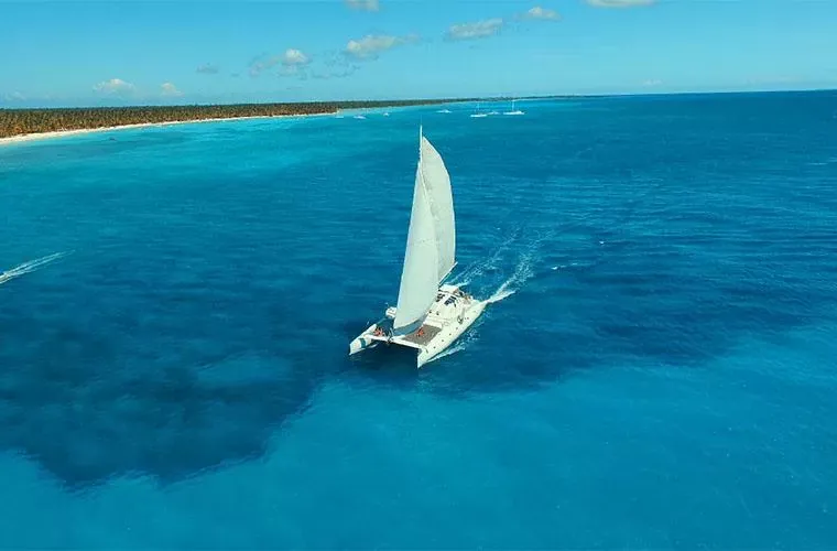 Aerial view of the catamaran crossing turquoise water near Saona Island