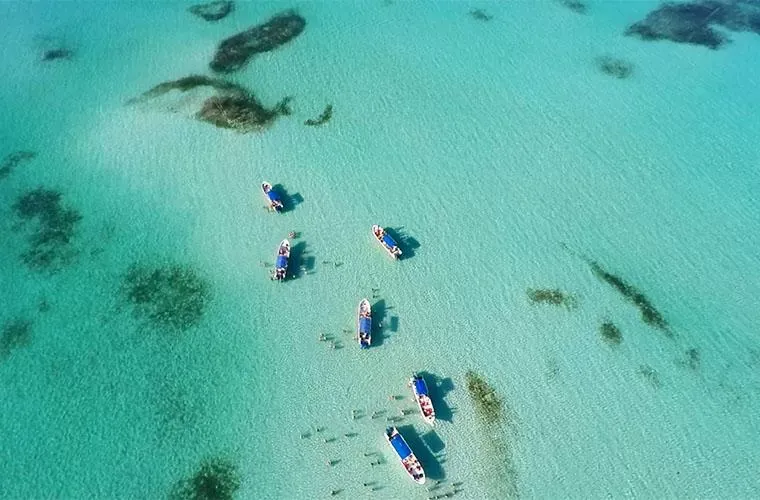 Aerial view of the natural pool with boats in the shallows